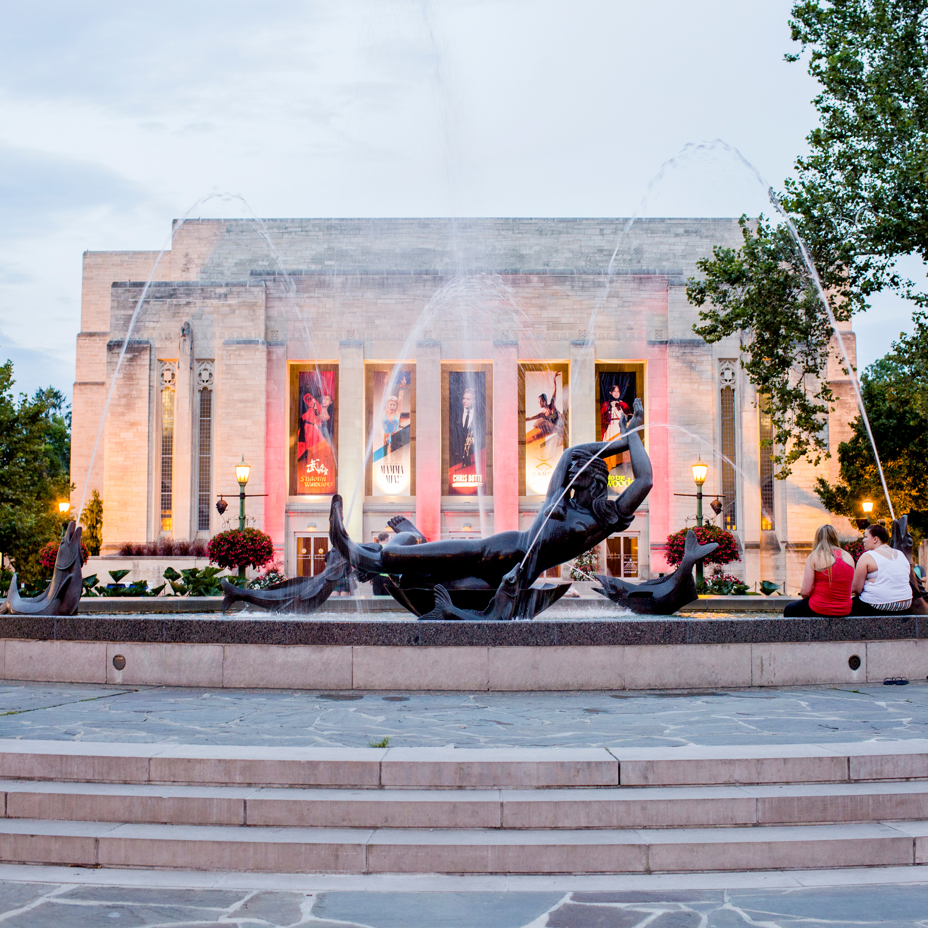 A shot of Indiana Auditorium, with the Venus fountain in front, with students on the right