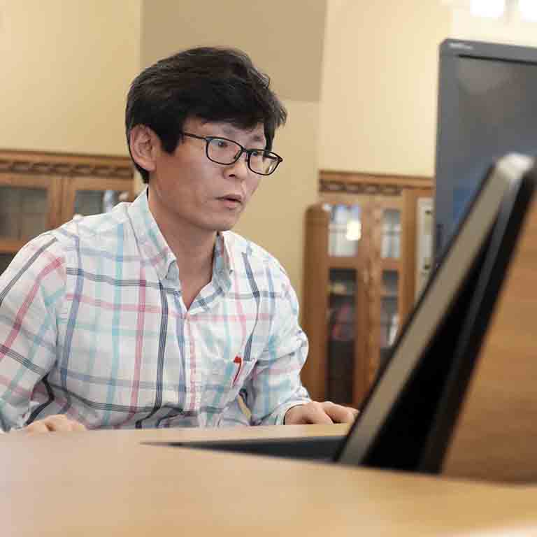 A student studies at a computer.