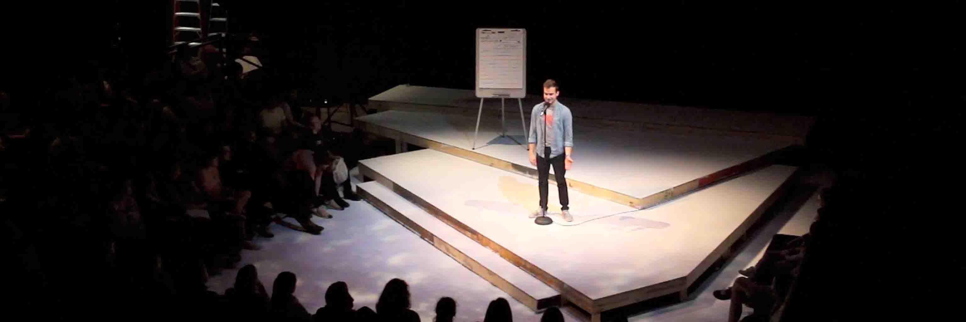 A Moth workshop participant tells a story onstage.