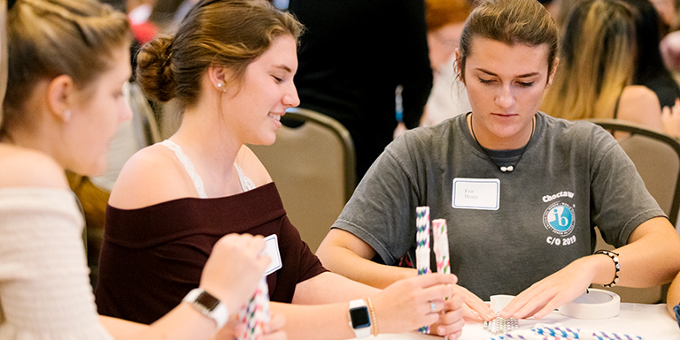 Three students working on an activity at a table