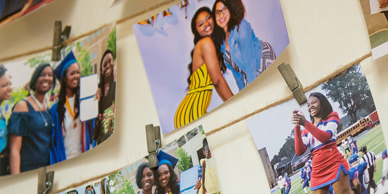 Photos displayed on a student's dorm room wall in the Atkins Living Learning Center
