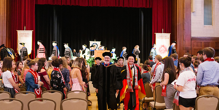 Dean Rick Van Kooten leading the procession of faculty out of the hall following the ceremony.